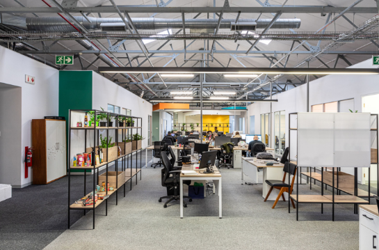 An office with a few people working on computersAI-generated content may be incorrect.