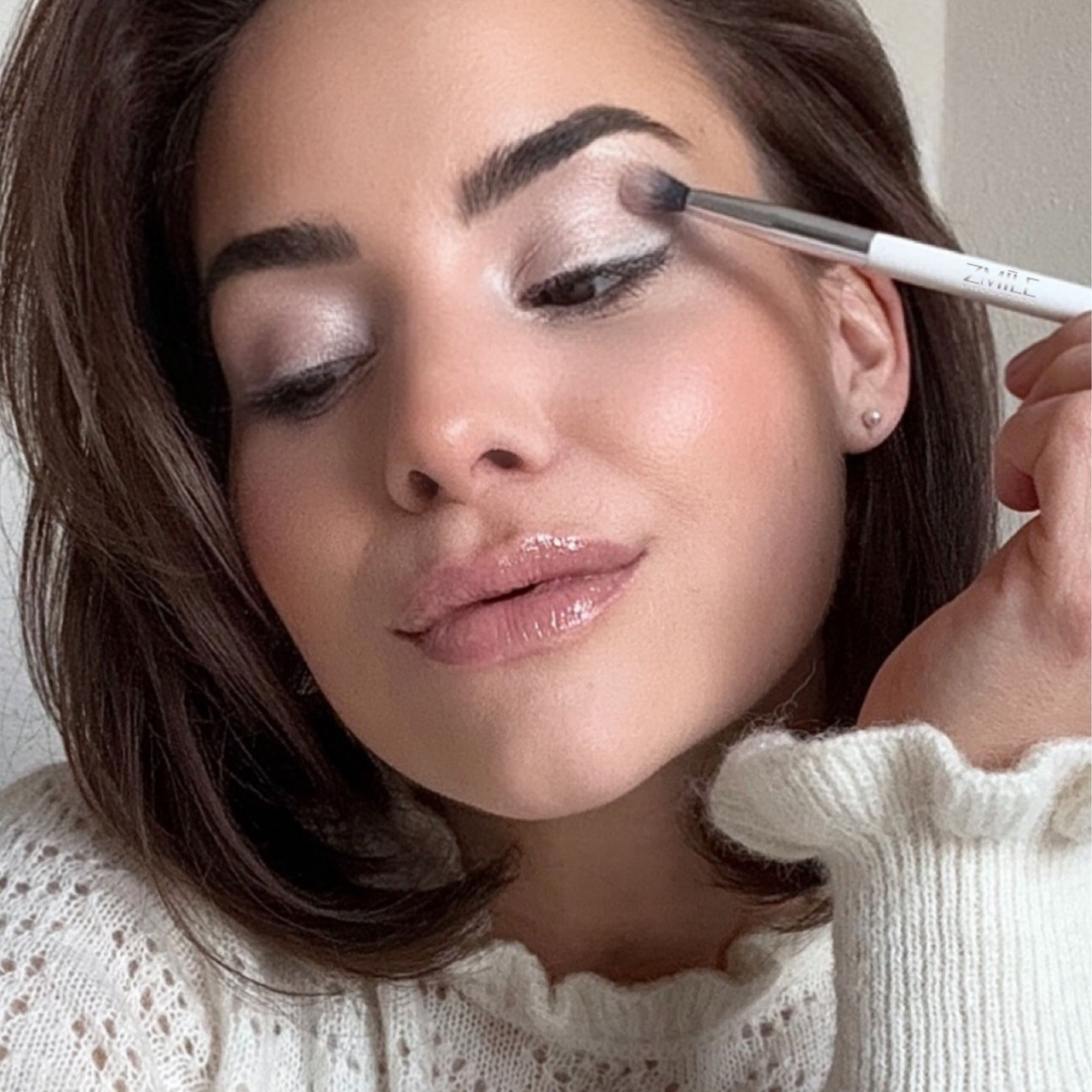 Junge Frau Close-Up mit Anwendungsbeispiel Kosmetikpinsel zur Verblendung von Lidschatten 