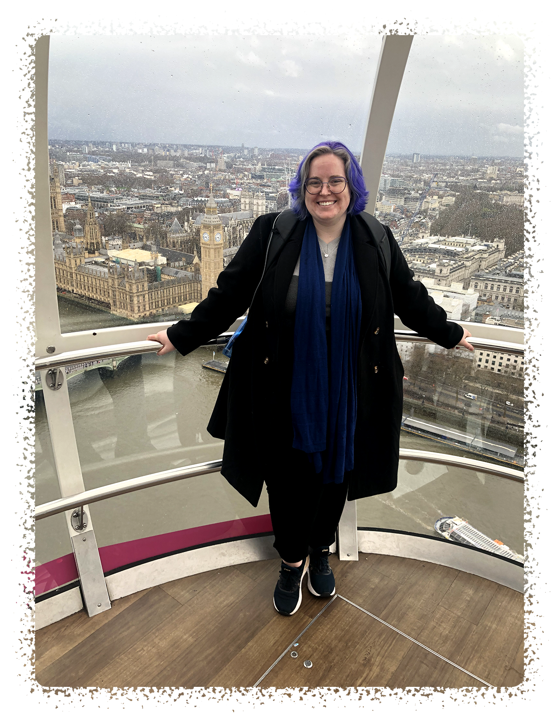 A blue-haired young woman on the London Eye, overlooking the Palace of Westminster