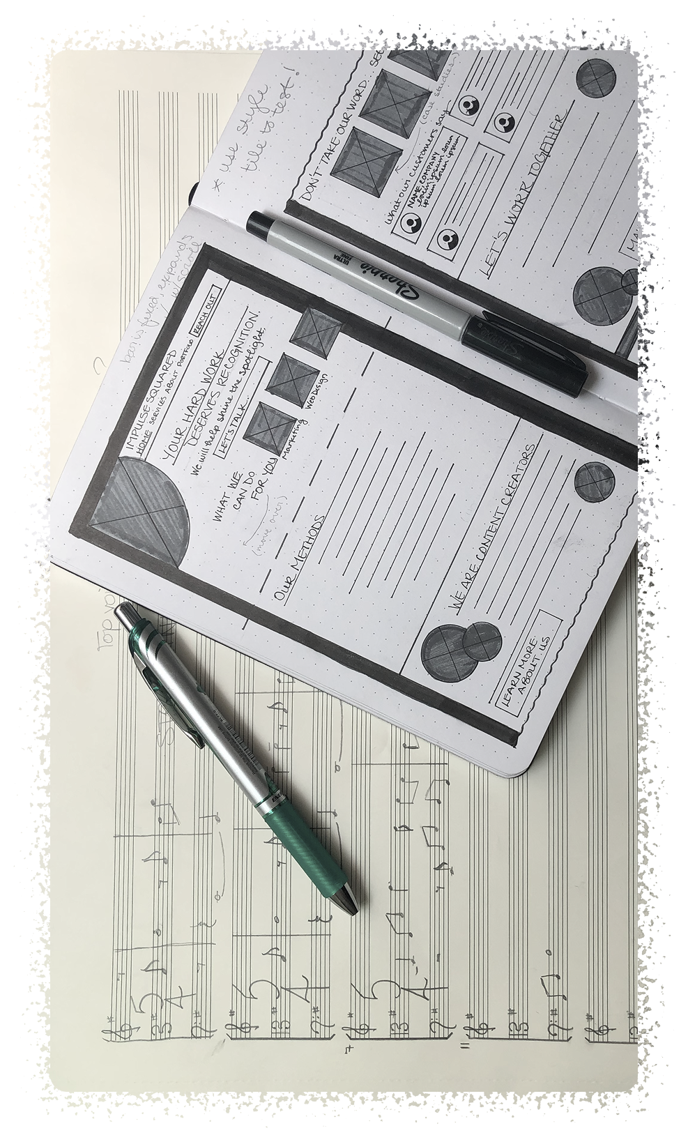 Hand-sketched wireframes and a handwritten musical score.