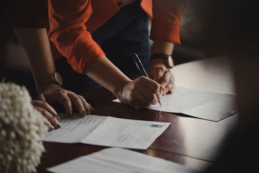 People signing a contract