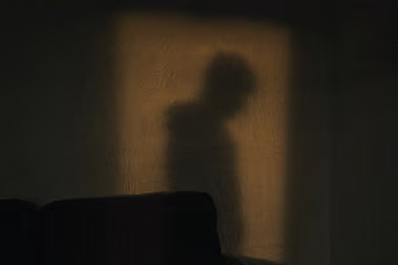 Person hiding in the shadows