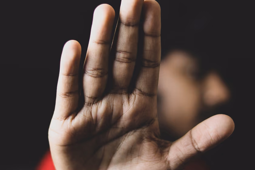 a blocking gesture with a hand