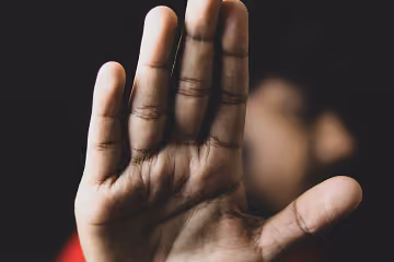 a blocking gesture with a hand
