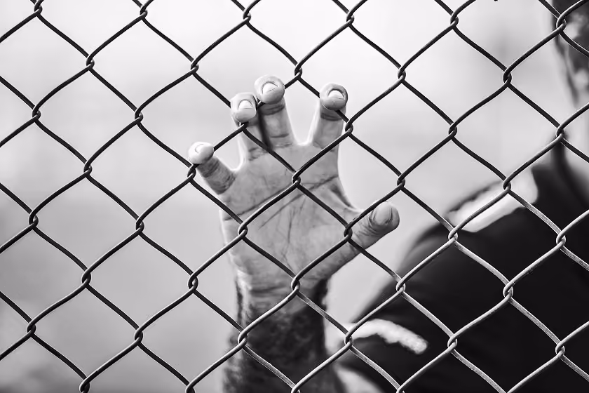Main behind a jail fence