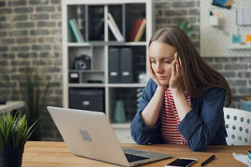 woman looking concerned at a laptop