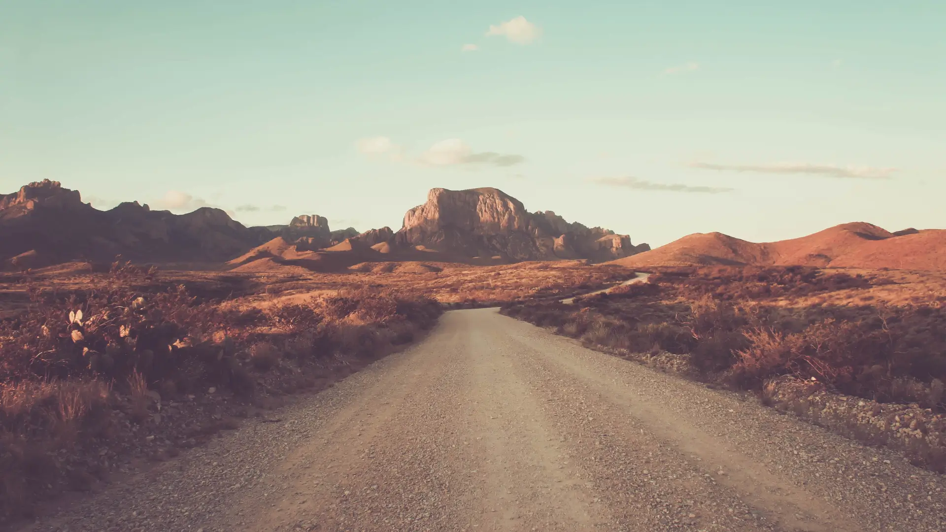 a dirt road in the middle of a desert