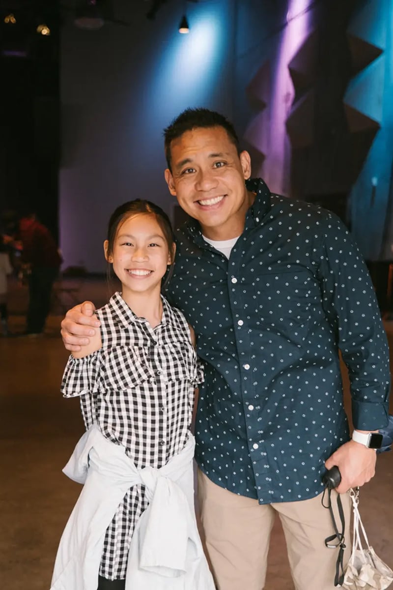 A man and a girl posing for a picture.