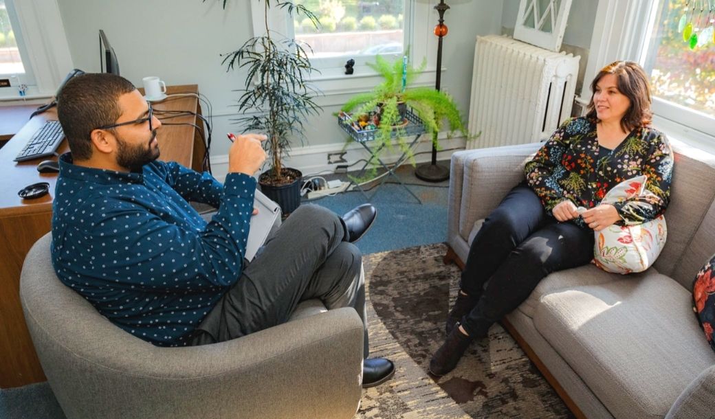 a family counselor in a therapy session with a woman
