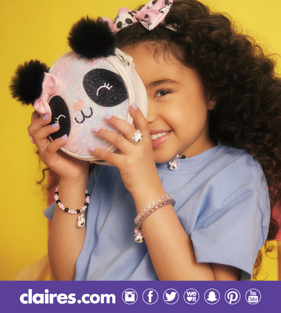 Young girl holding up a panda pouch