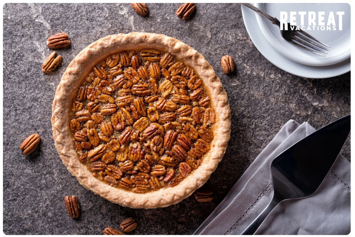 Close-up of a freshly baked Southern pecan pie with a golden crust, topped with glistening pecan halves, showcasing the rich and nutty flavors of Tennessee.