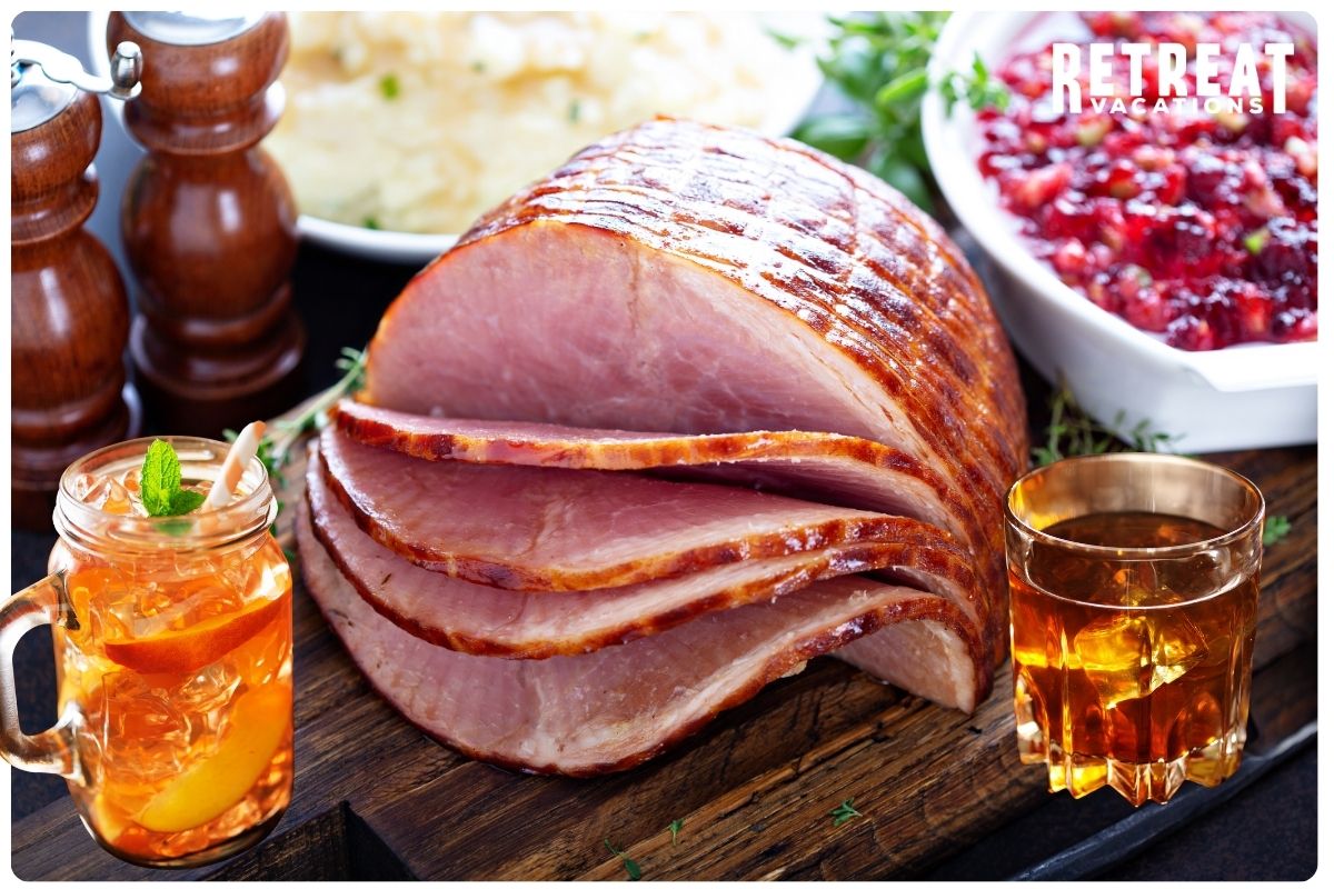 Succulent glazed ham with a caramelized sweet tea and bourbon coating, garnished with fresh herbs, served on a rustic platter for a classic Southern holiday centerpiece.
