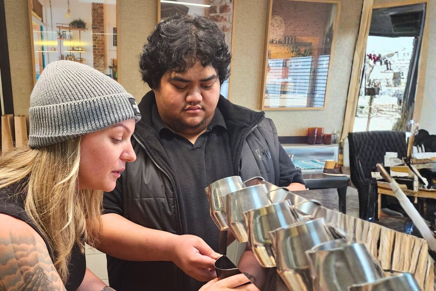 A rangatahi learns the art of coffee making during a barista course.