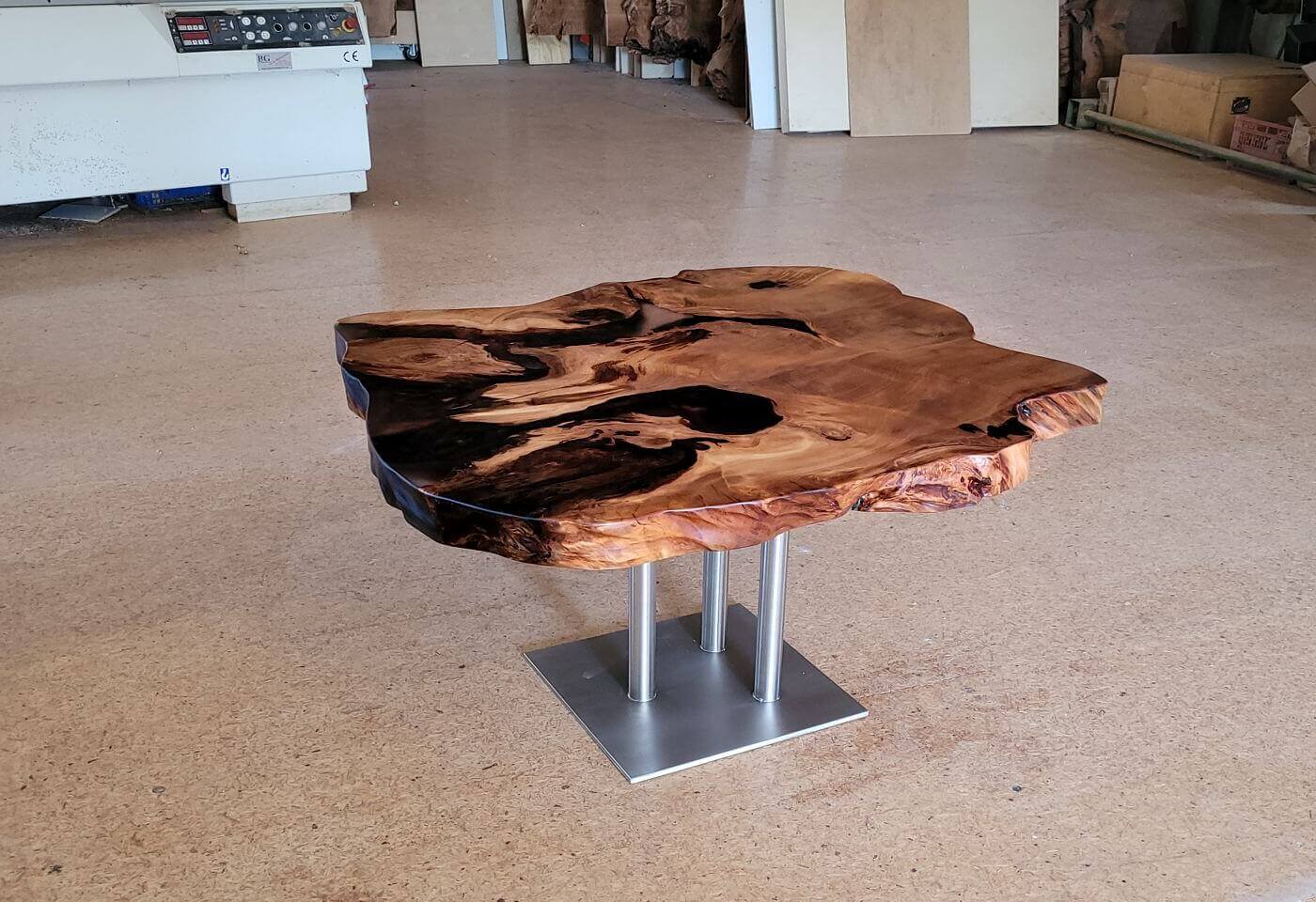 Coffee table as an incomparable designer work of art and unique piece of nature with individual stainless steel base frame as a valuable wooden table