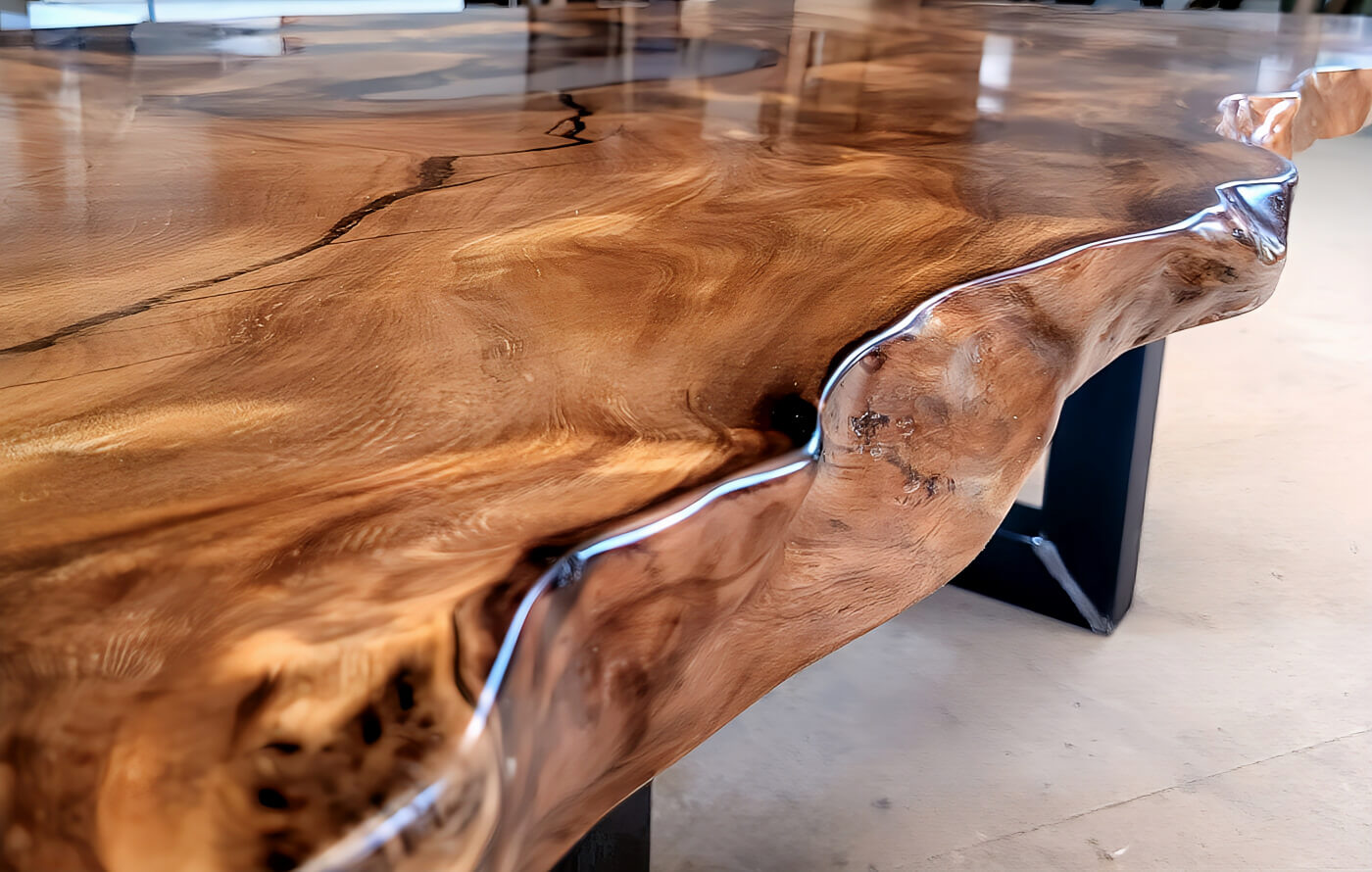 Organic tree edges of an extraordinary real wood table made of rare natural wood as an unusual dining table with an old solid real wood table top