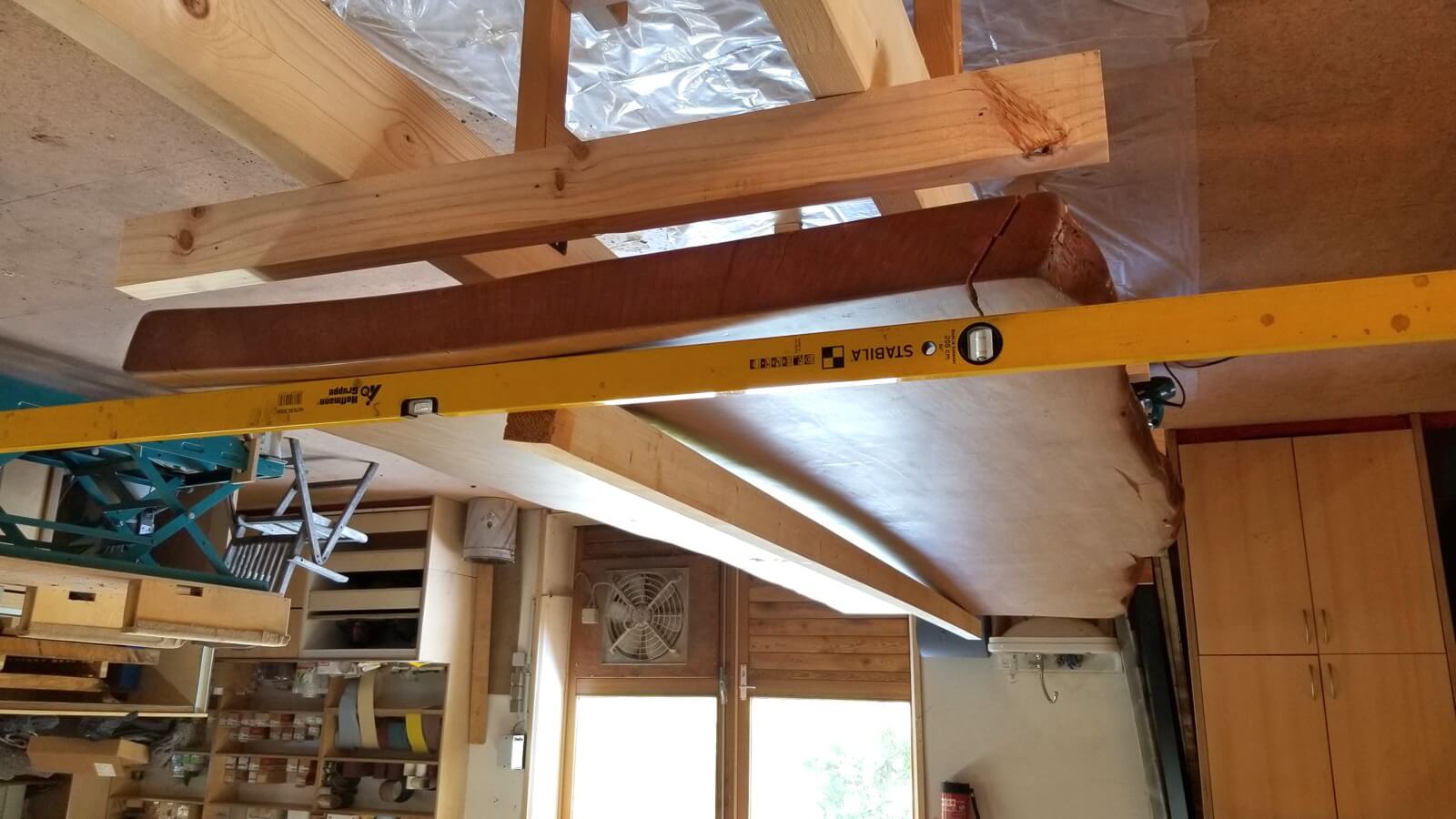 Distortion of the large solid wooden tabletop after professional topping