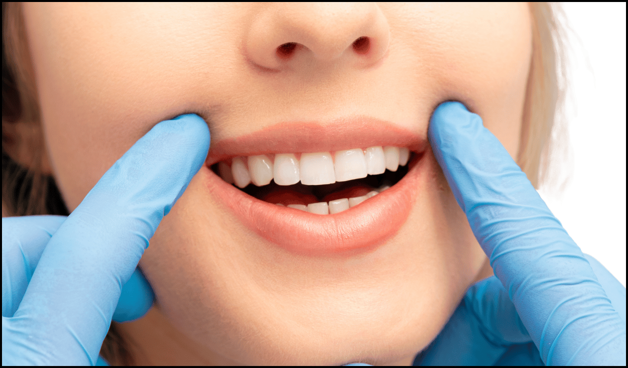 Woman standing and brushing her teeth in front of a mirror, promoting dental health