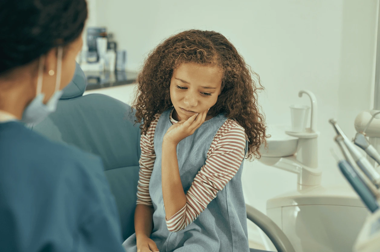 Child with tooth pain visiting Main Street Dental in Vista, CA for professional care