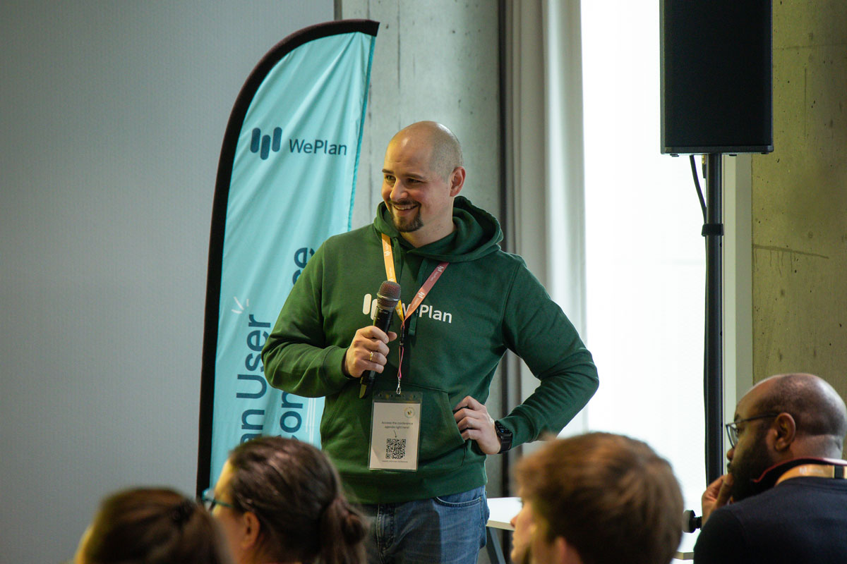 Stefan Ries, Product Owner at WePlan, talking on stage at a WePlan User Conference in Frankfurt