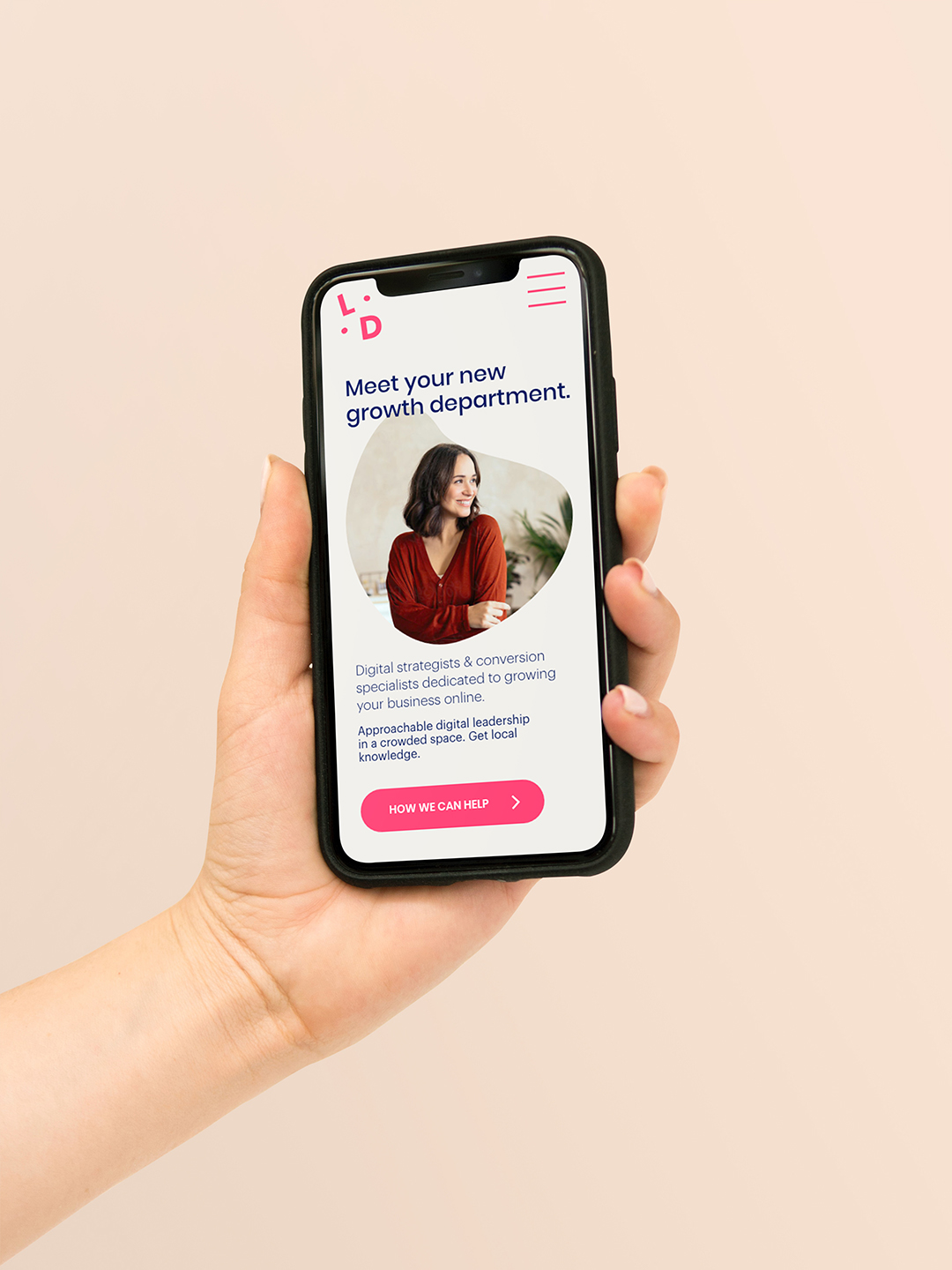 Hand holding phone with Local Digital landing page on screen