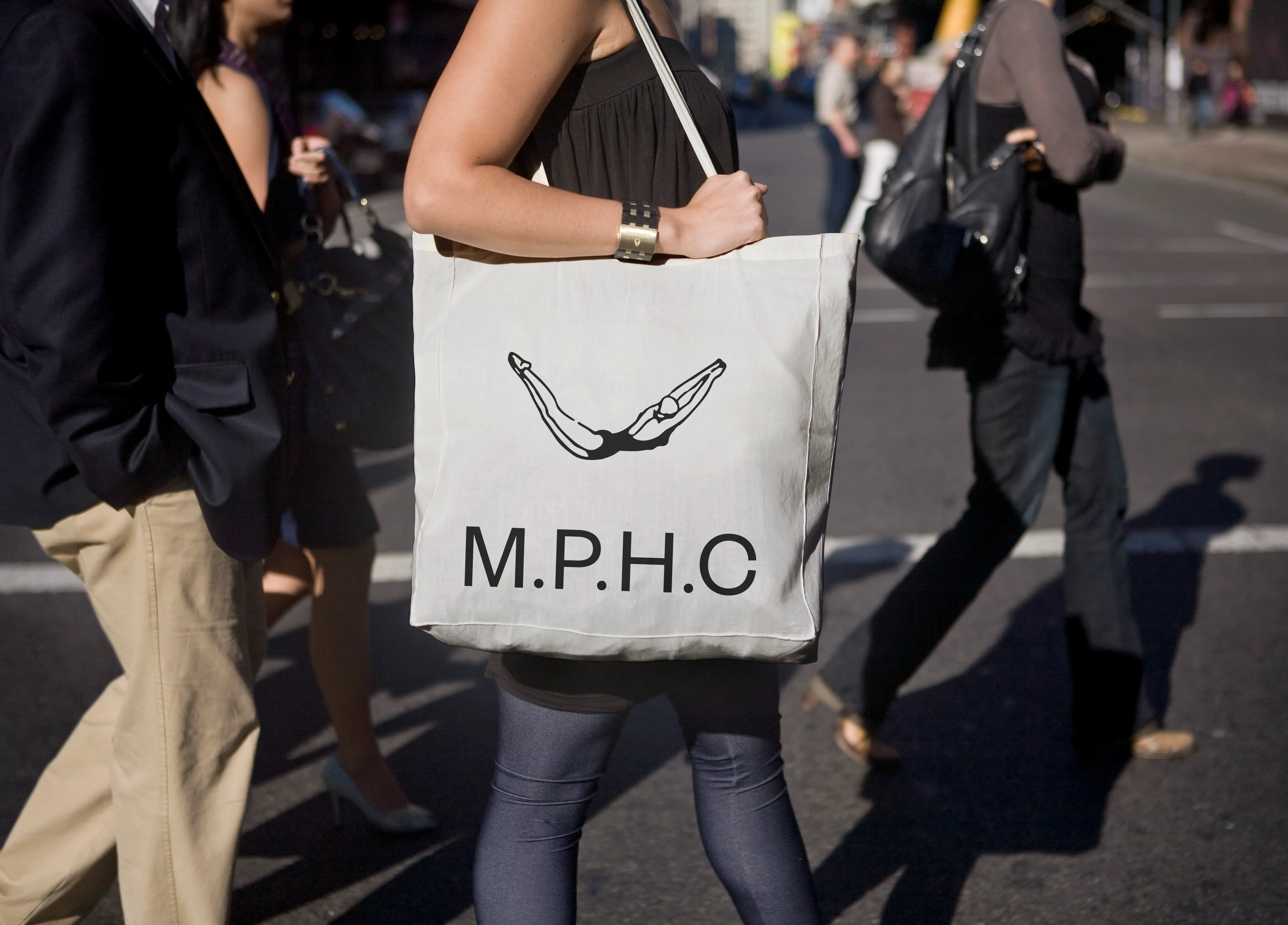 woman holding white totebage with MPHC branding on side