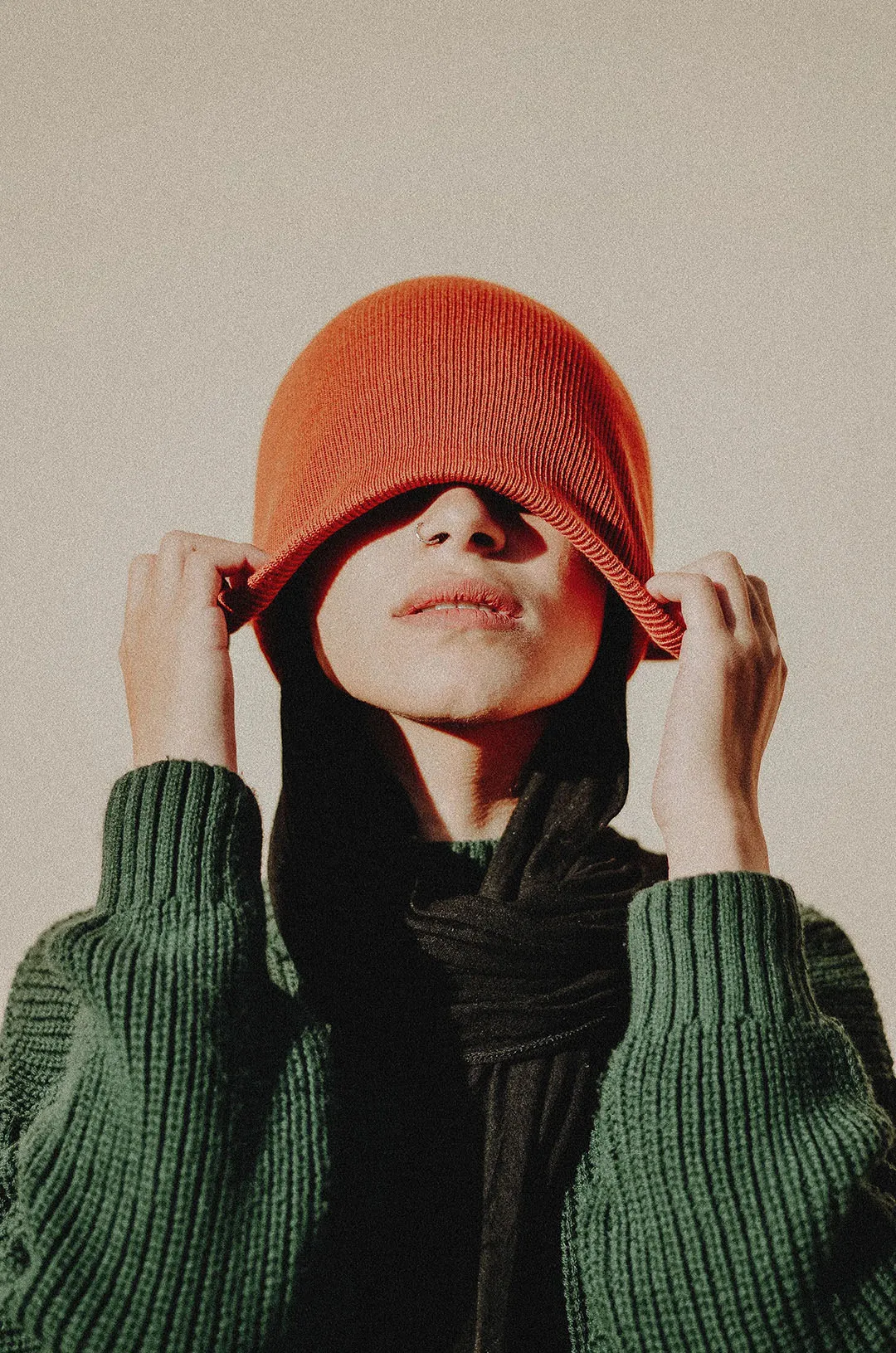 Woman pulling beanie over her eyes