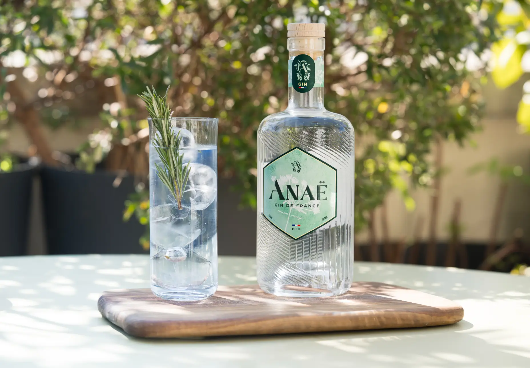 Bouteille de gin Anaë bio avec cocktail frais au romarin et glaçons