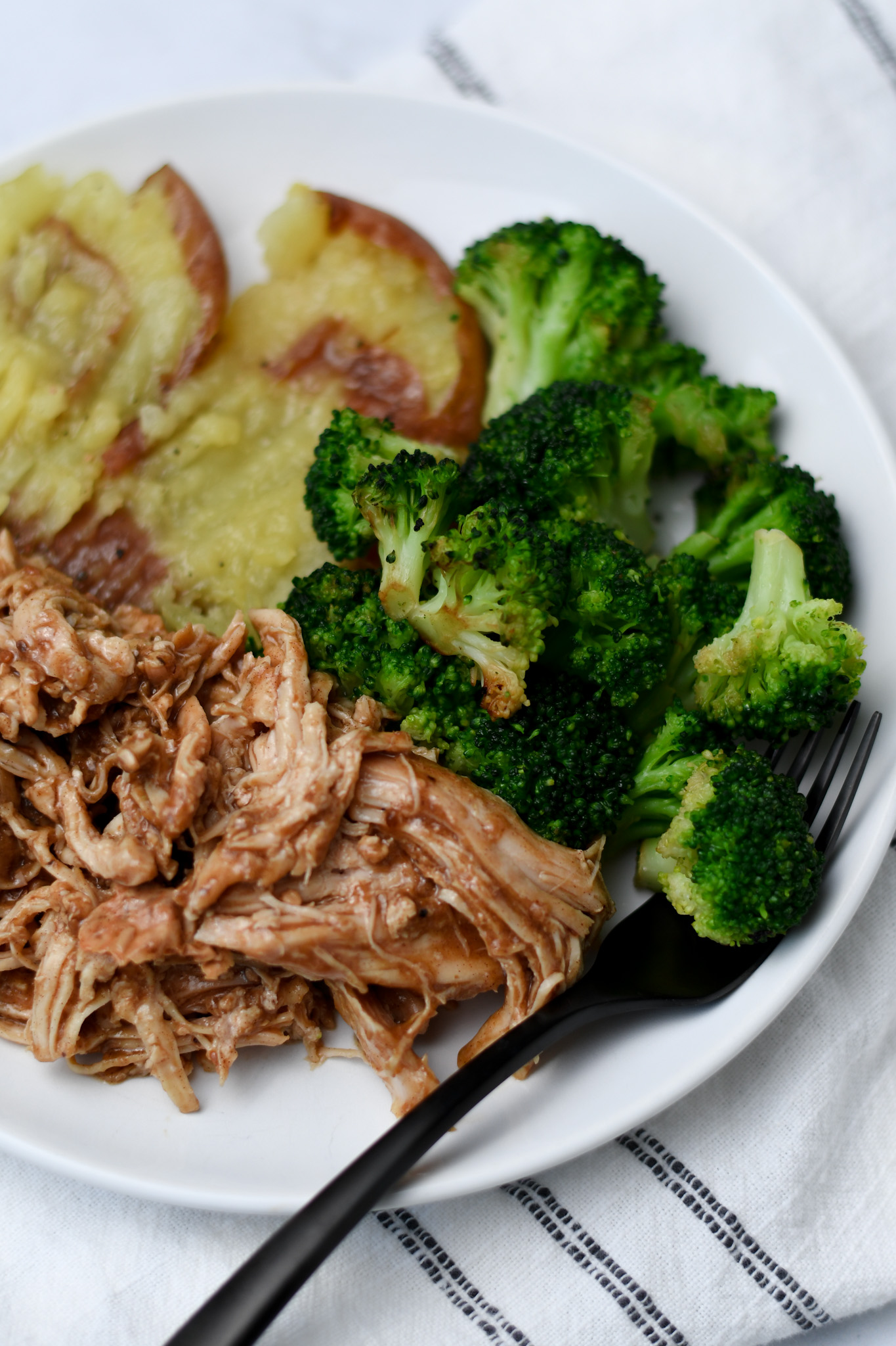 shredded chicken with teriyaki sauce and roasted broccoli