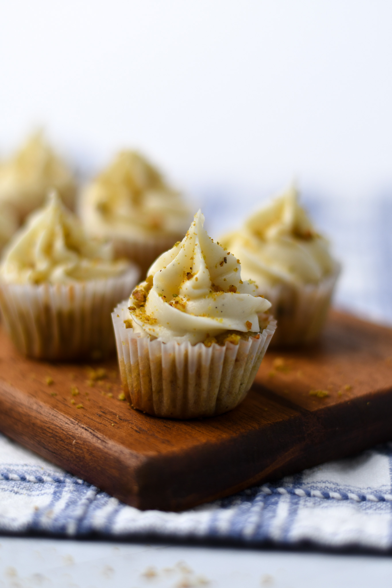 Side view of gluten free mini pistachio cupcakes on a cutting board