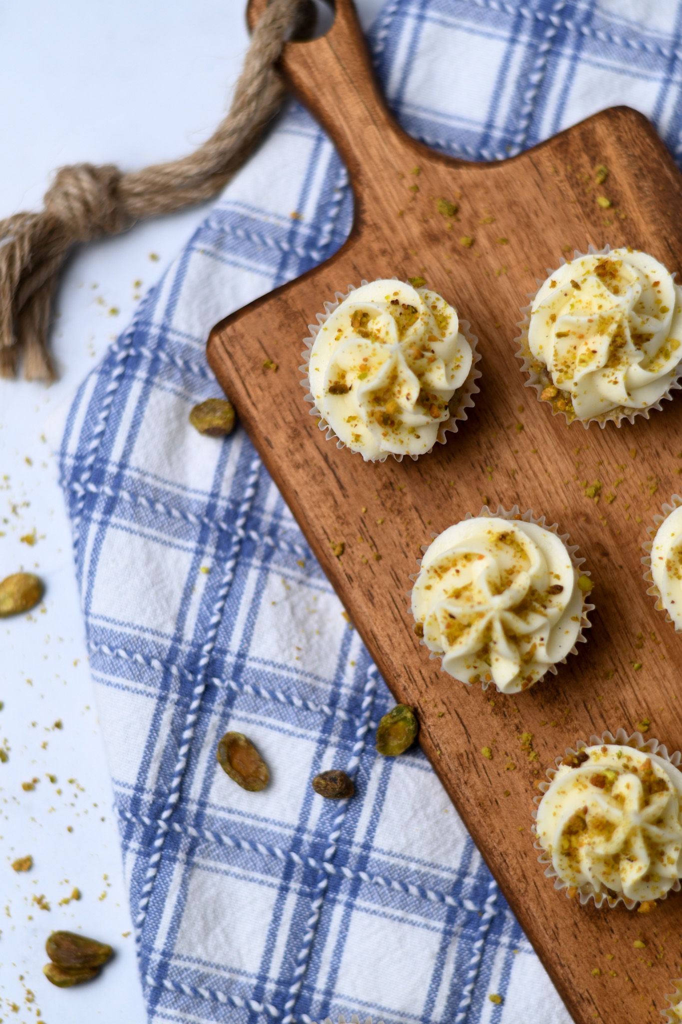 Gluten Free Mini Pistachio Cupcakes on a Wooden Cutting Board