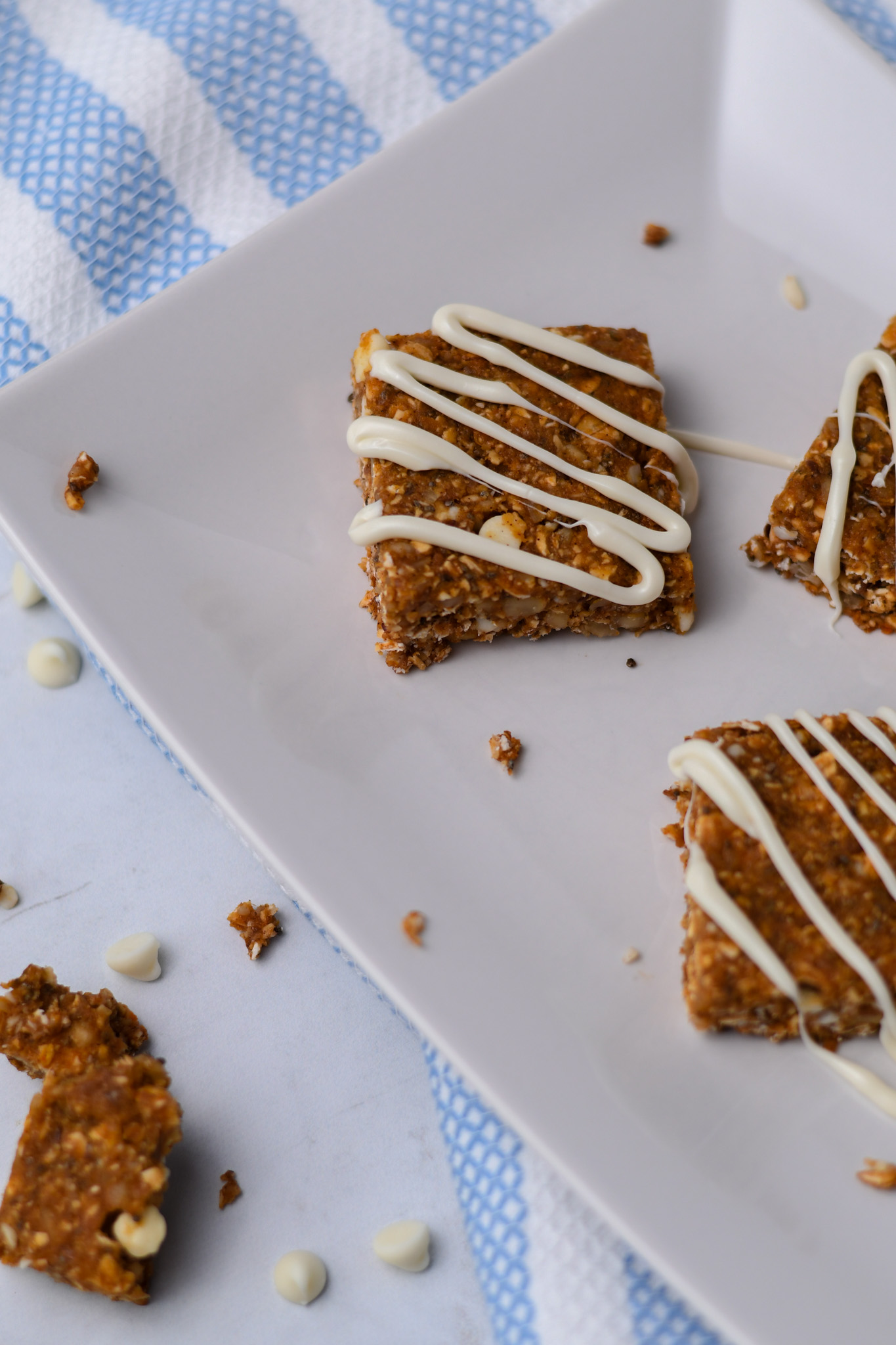Homemade pumpkin granola bars with a white chocolate drizzle