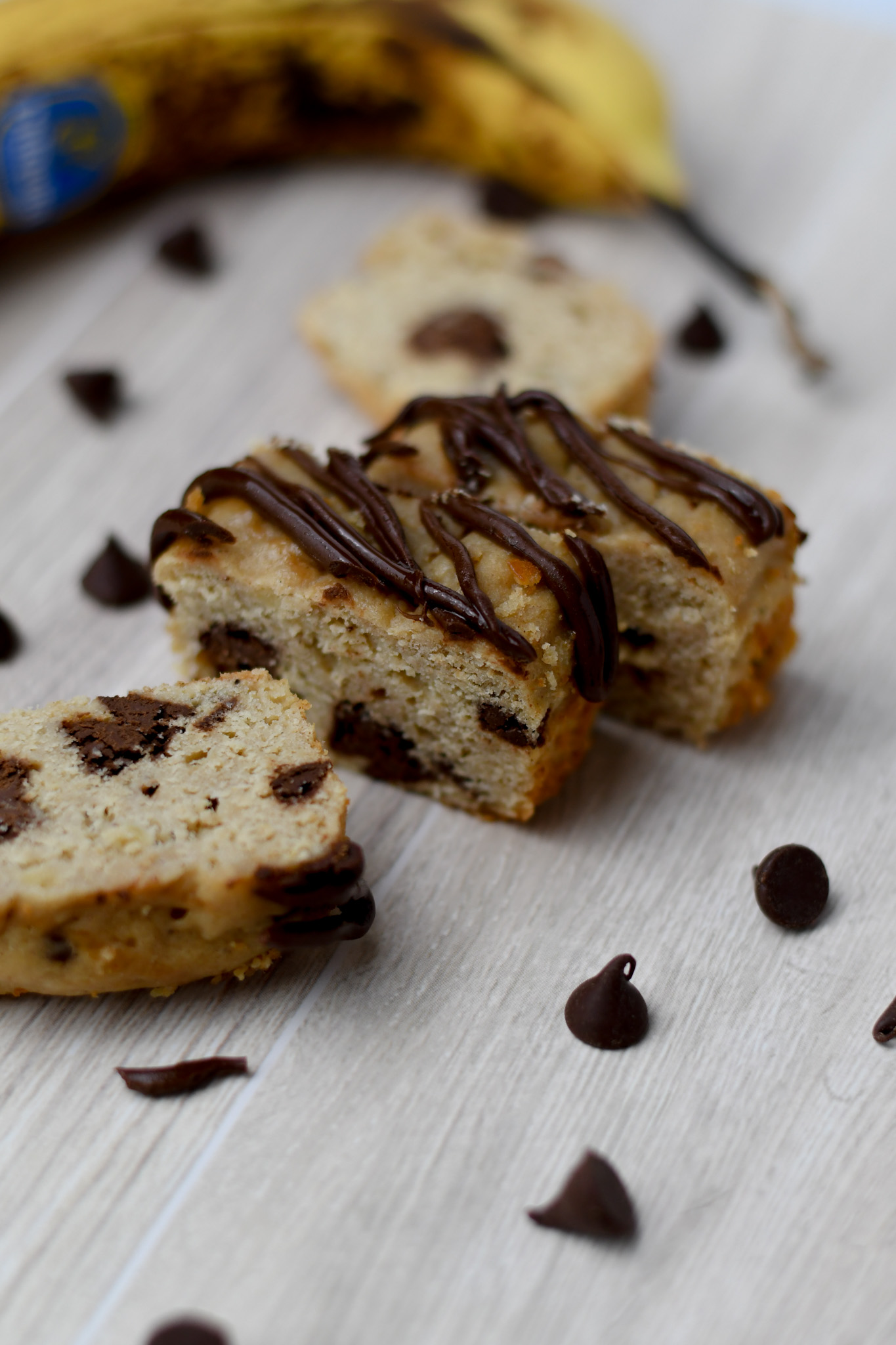 mini slices of gluten free banana bread with protein and a chocolate drizzle