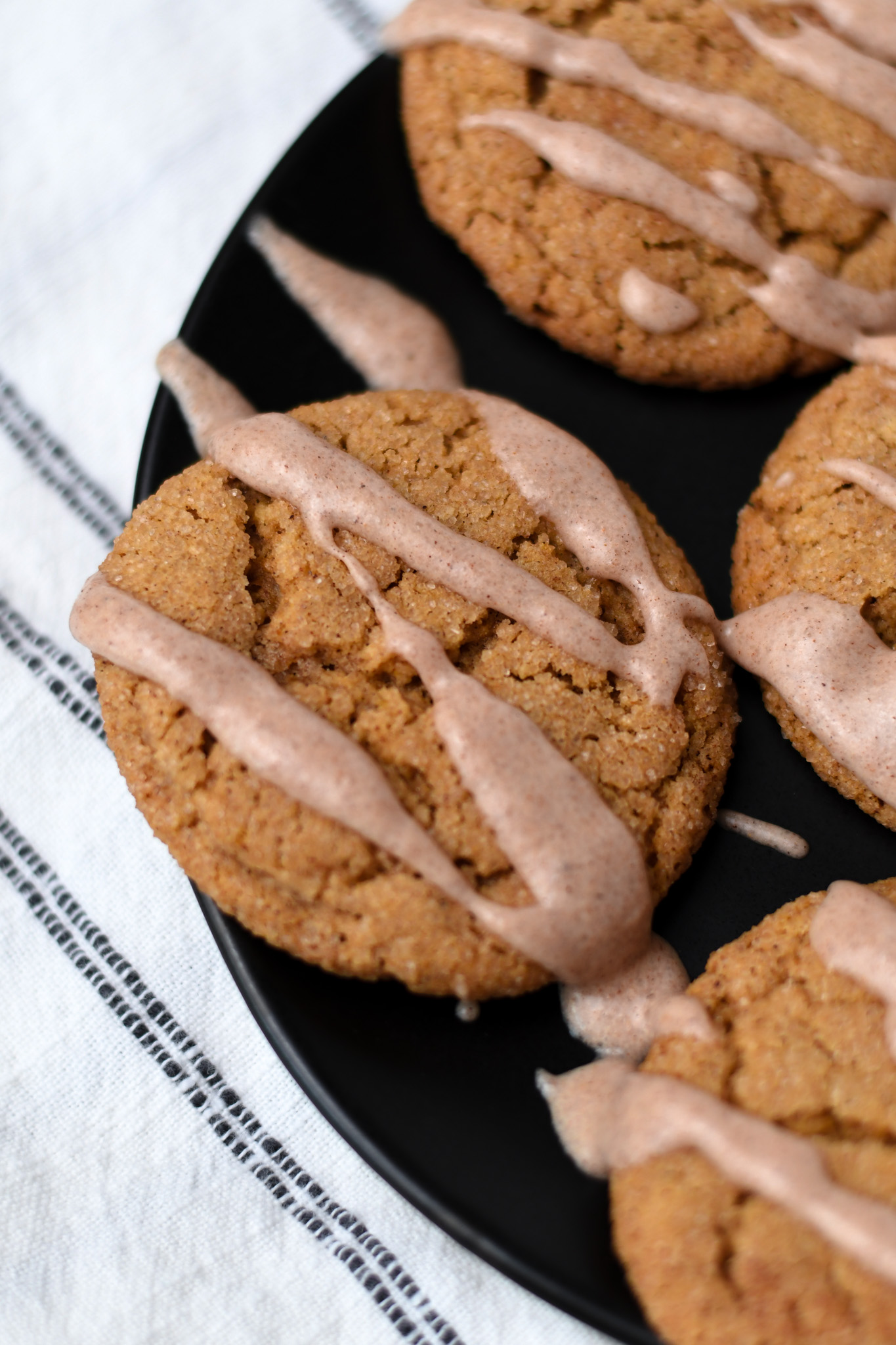 a plate of gluten free pumpkin cookies with a cinnamon drizzle