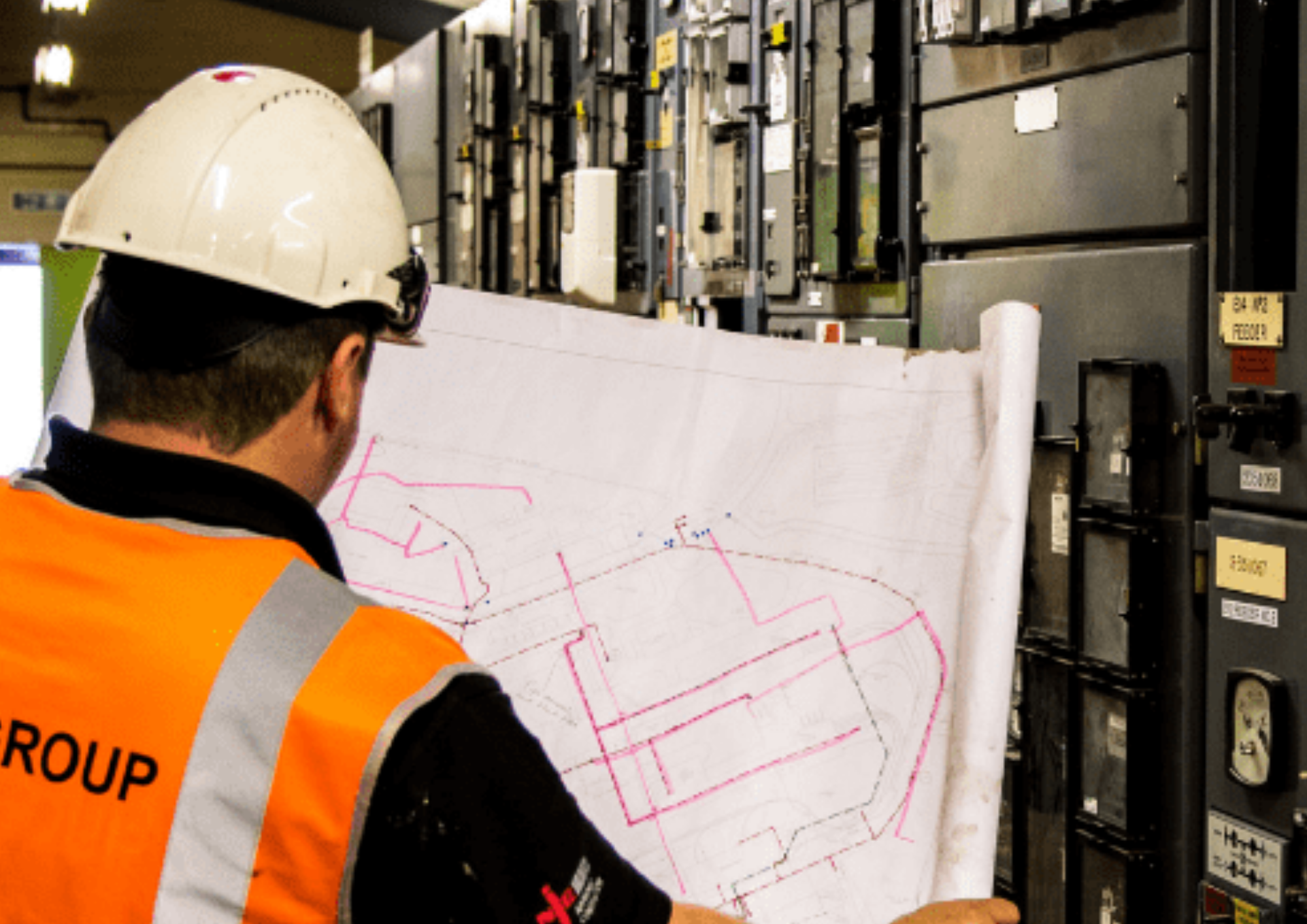 A machinist wearing a safety gear is examining an exit strategy for the machinery room