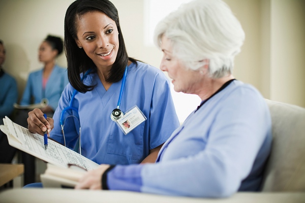 A licensed practical nurse explaining the medical record of her patient