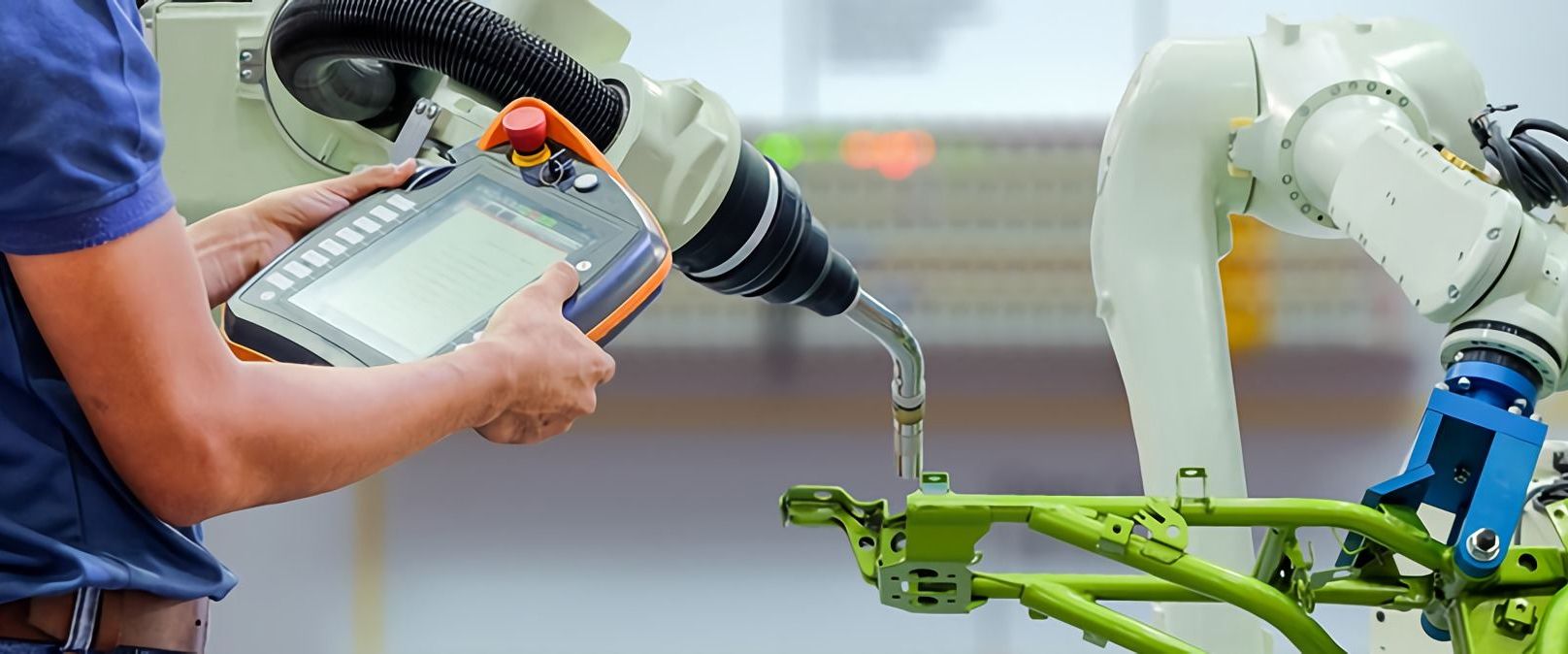 A robotic welder operator operating a robotic welder controlling its movements and functions