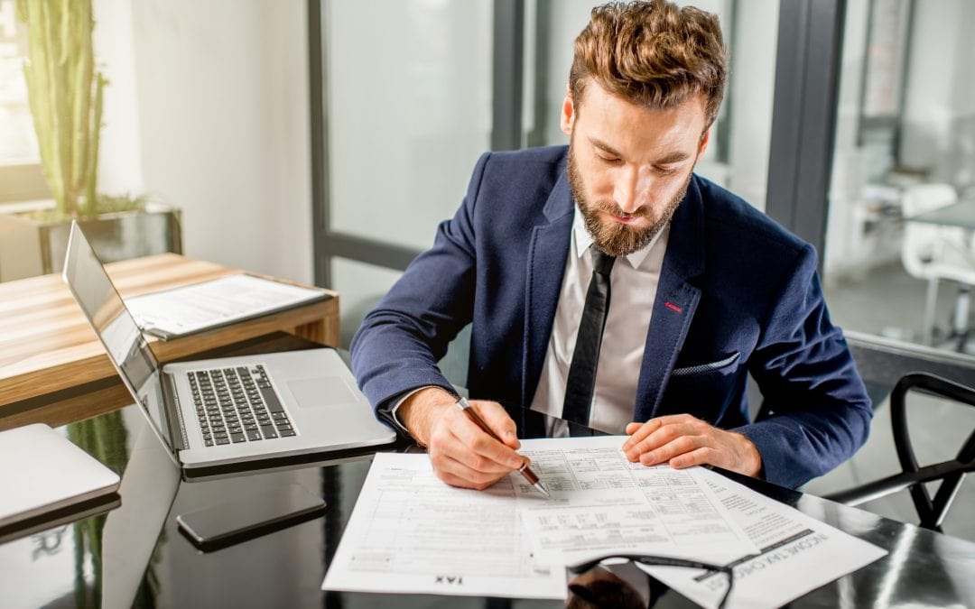 Accounting technician is checking the financial statements of his client