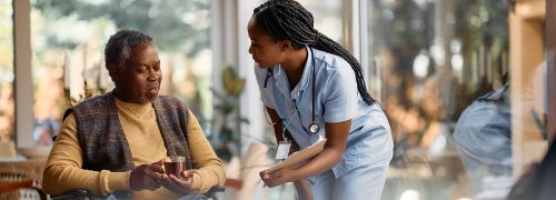 CBRF Personnel talking to her patient possibly monitoring health conditions of the patient