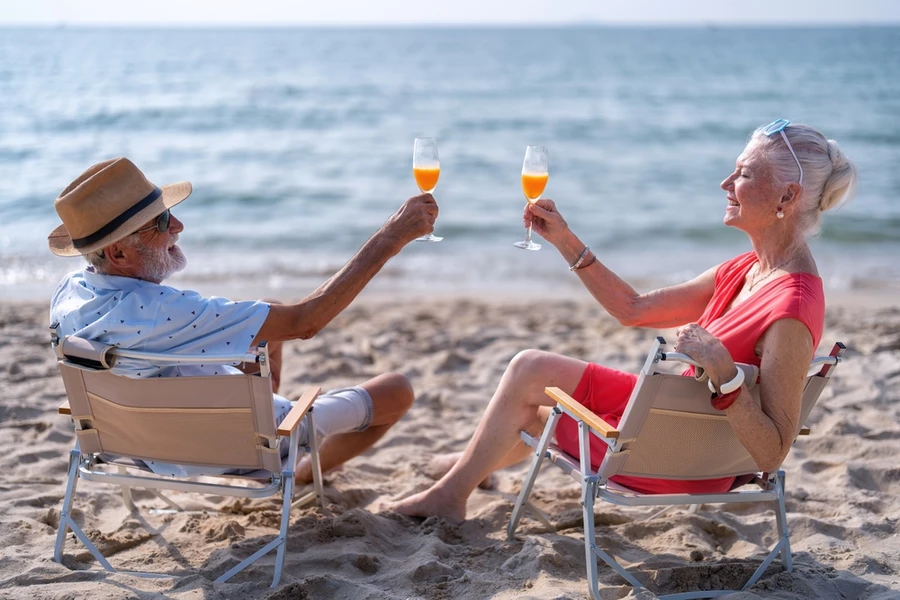 Retired older couple relaxing on beach