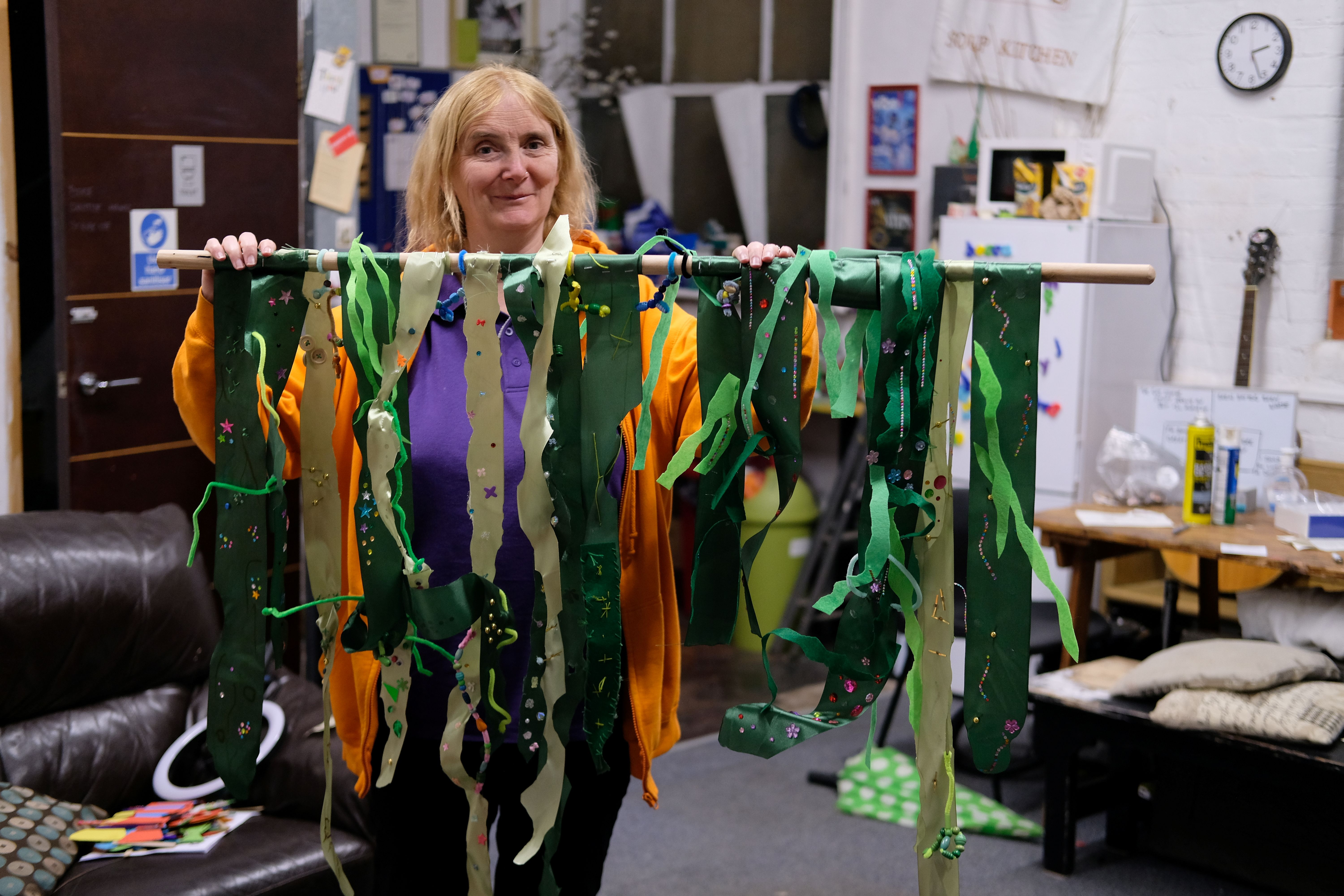 Woman holding up recycled theatre props