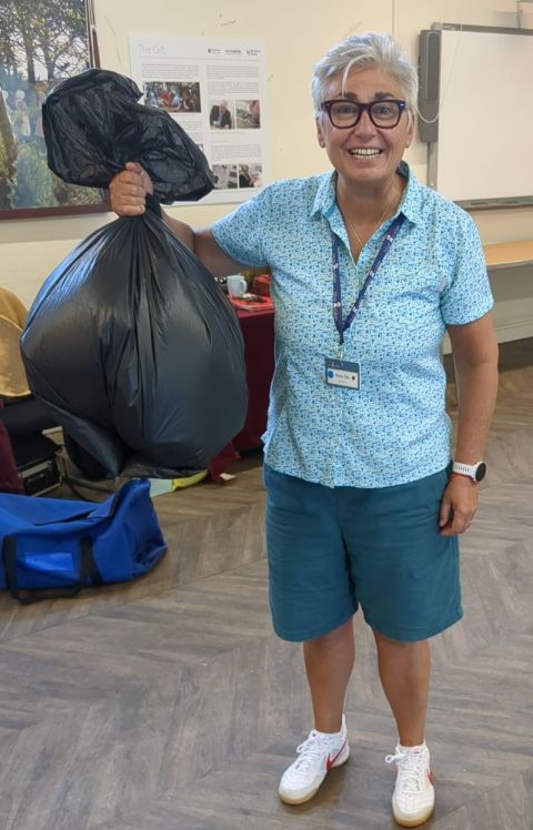A participant holding up a bag of rubbish for auditing
