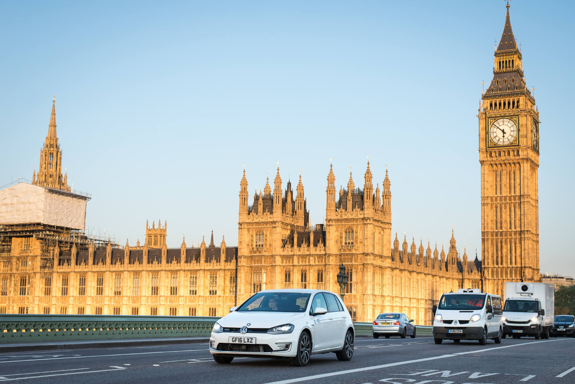 Car club vehicle passing the houses of parliament