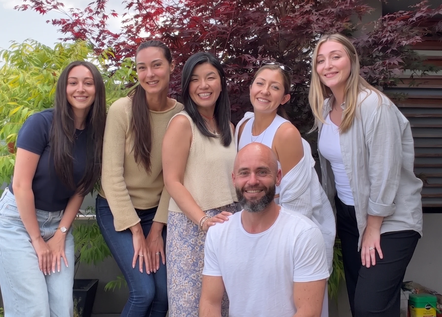 St. Royal Entertainment team posing outdoors together, with five women and founder Andrew St. Royal smiling for a casual team photo.