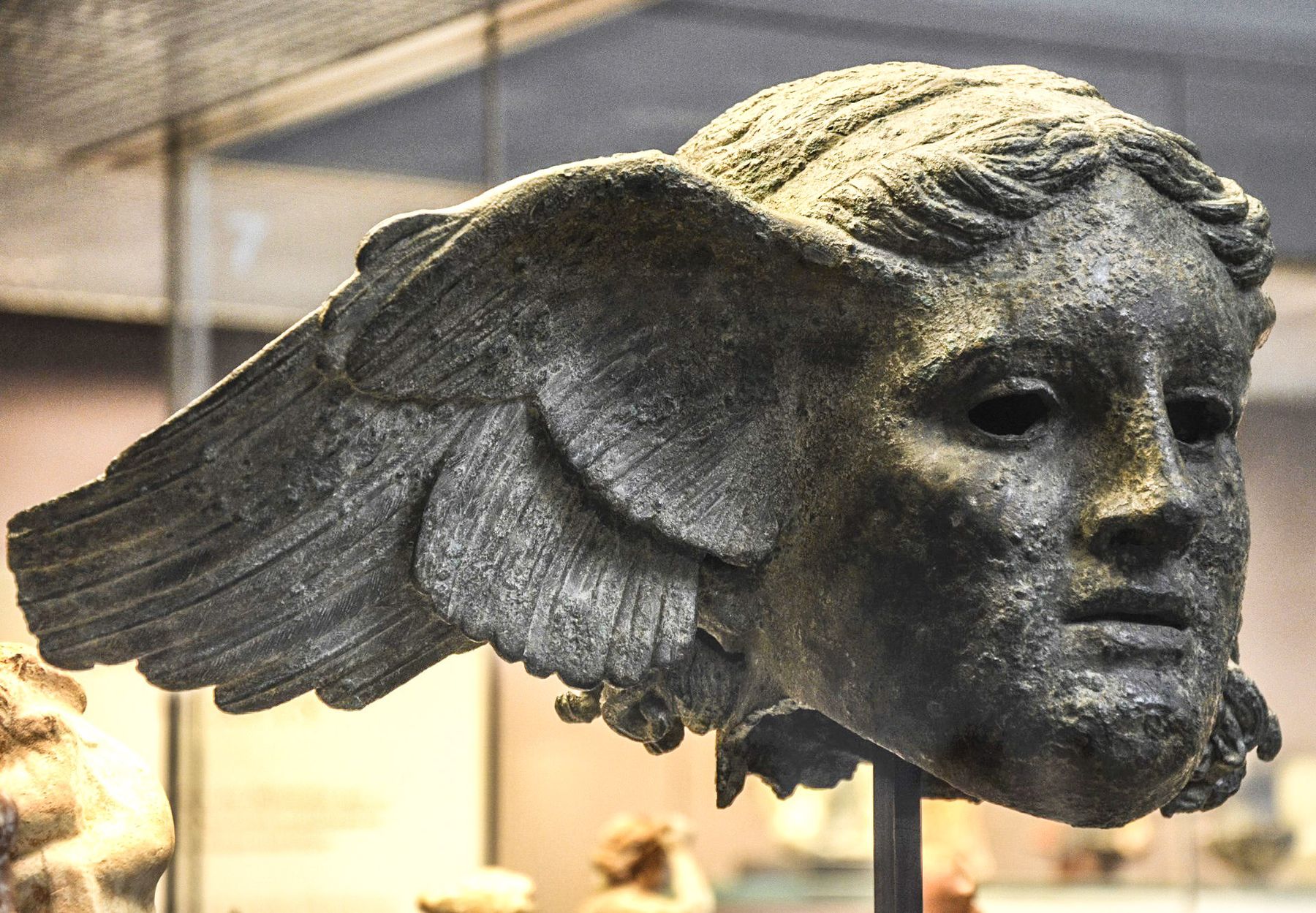 Roman bronze head of Hypnos, god of sleep, with a wing at the temple