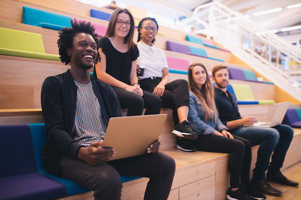 Group of diverse people smiling in a school working setting 