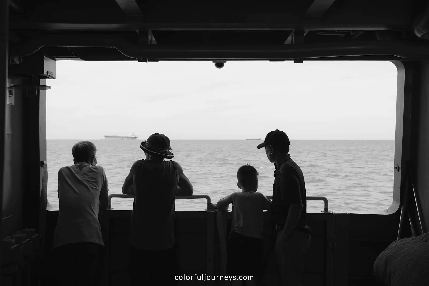 People look over the ocean on a ferry to Vung Tau, Vietnam