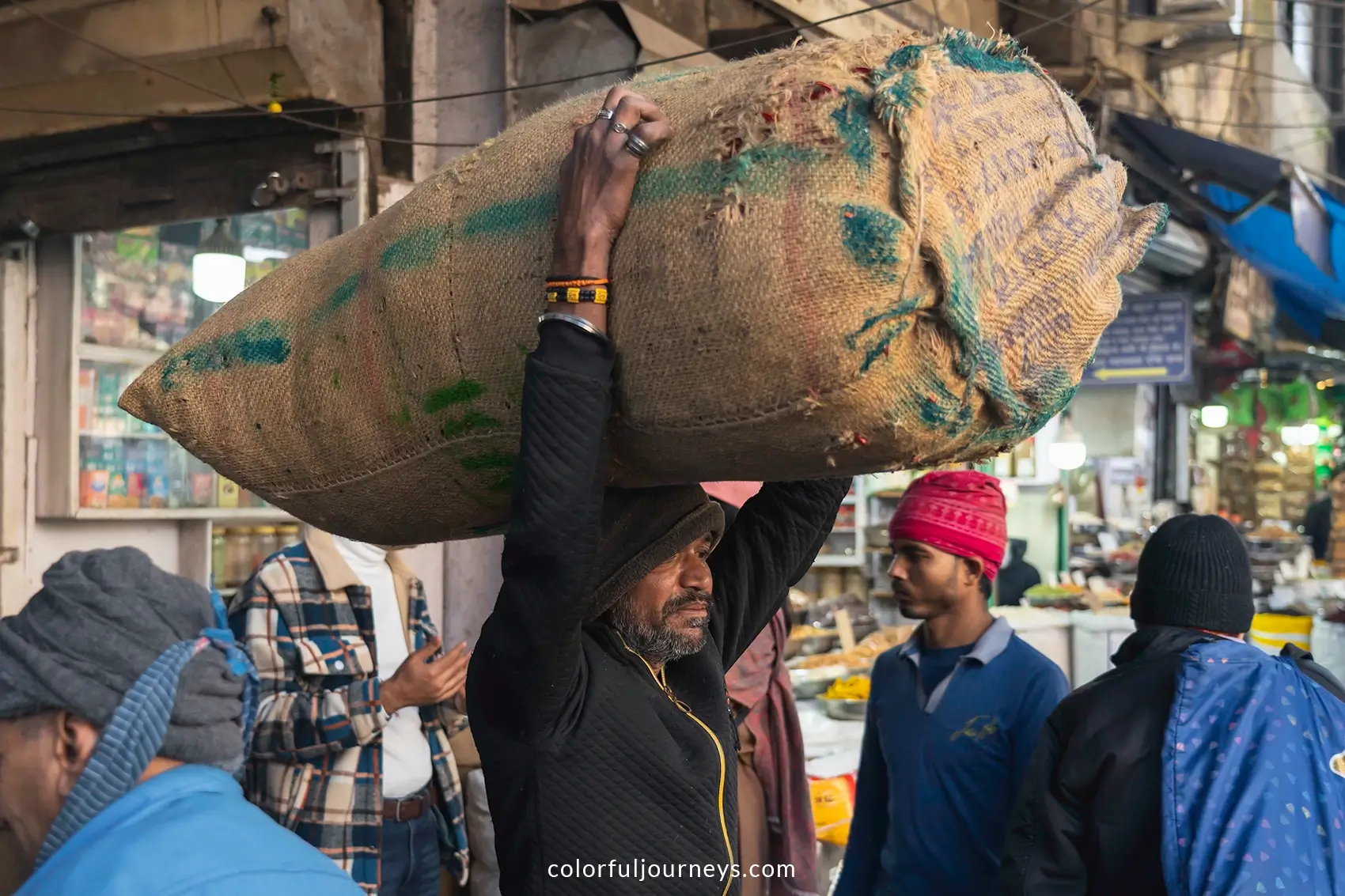 A man carries a sack above his head in Delhi, India