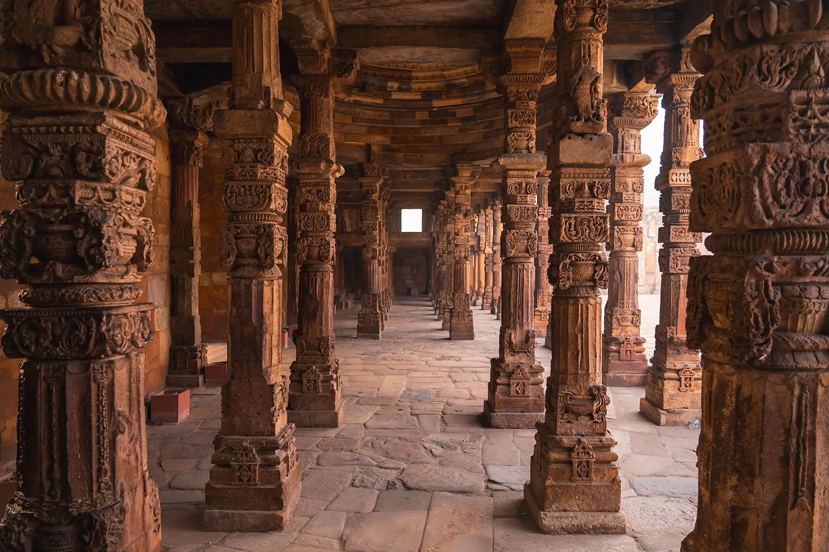 Intricately designed pillars at Qutub Minar in Delhi, India