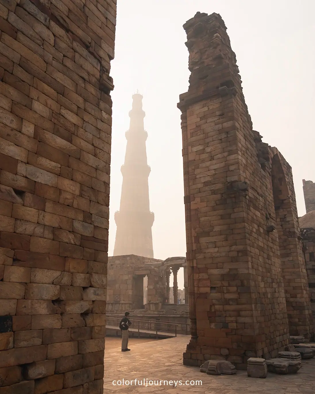 A young man explores the ruins of the Qutub complex in Delhi, India