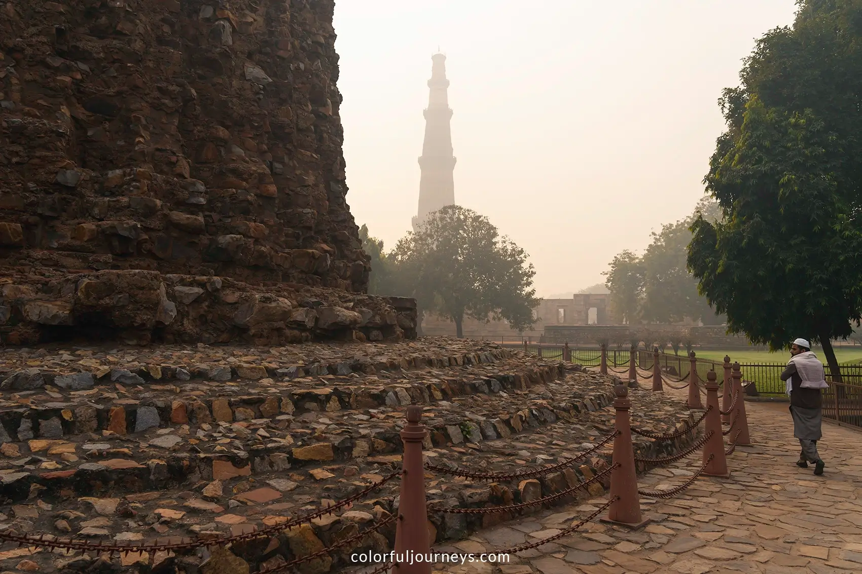 A man walks around the base of Alai Minar in Delhi, India